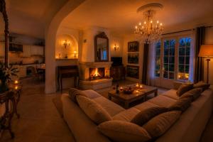 a living room with a couch and a fireplace at Villa Daurus in Vallauris