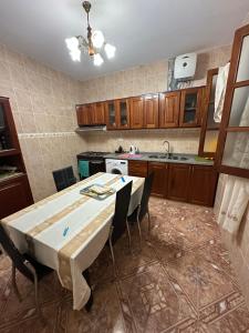 a kitchen with a table and chairs in it at Recanto da Paz in Tarrafal