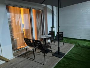 a patio with chairs and a table on a balcony at Dina's Rooms Himara in Himare