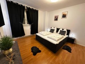 a bedroom with a bed in a room with black curtains at Lesum View Apartment Bremen in Bremen