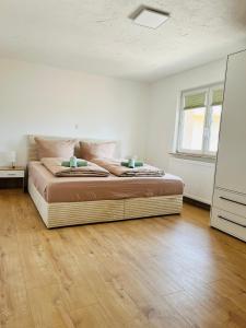 a bedroom with a bed with a wooden floor at Ferienhäuser Radebeul "Maisonette Klein Nizza" in Radebeul +13 photos