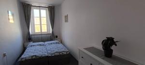 a bedroom with a bed and a potted plant at Apartmán Náměstí Hostinné in Hostinné +26 photos