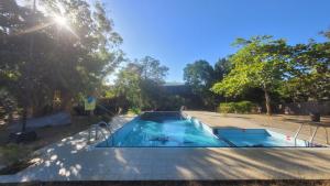 a swimming pool in a yard with trees at Vintara Wild Hambanthota in Hambantota