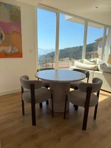 a dining room with a table and chairs and a couch at Casa Broullón in Moaña