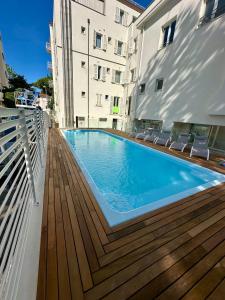 a swimming pool on the deck of a building at hotel Torretta Bramante in Rimini +39 photos