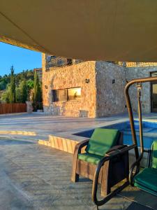 a chair sitting under a tent next to a pool at مزرعة لافين in Jerash