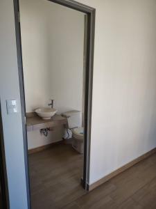 a bathroom with a toilet and a sink at Chepicche Inn in Oaxaca City