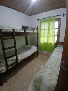 a bedroom with two bunk beds and a window at Cabañas amanecer alegre in Salta