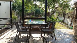 a table and four chairs on a patio at House with garden in Agria