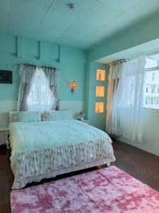 a bedroom with a large bed and a pink rug at VV House and Cinema 2 in Quy Nhon