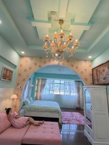 a girl laying on a couch in a bedroom at VV House and Cinema 2 in Quy Nhon