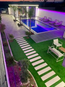 an overhead view of a swimming pool at night at Aurora villa in Rrushkull