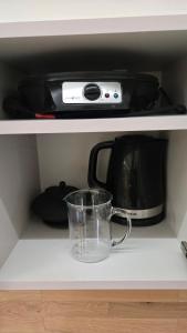 a microwave and a toaster oven on a shelf at OLA I Oáza Les Atmosféra I Oasis Forest Atmosphere in Petrov +24 photos