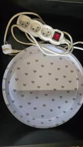 a white bowl with a controller on top of it at OLA I Oáza Les Atmosféra I Oasis Forest Atmosphere in Petrov