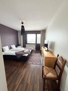 a bedroom with a bed and a desk in it at Lysekil Apartment Hotel in Lysekil