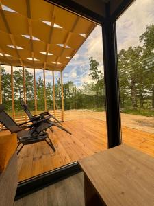 a room with a view of a wooden deck at Piva Chill in Plužine