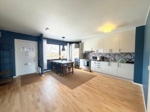 a kitchen with a table and a dining room at Lysekil Apartment Hotel in Lysekil
