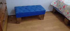 a blue bench in a bedroom with a bed at José Coro in La Serena