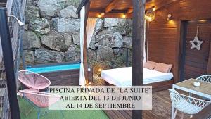 a room with a bed and chairs on a patio at NidoGredos Cabañas Ecológicas de Diseño in El Tiemblo