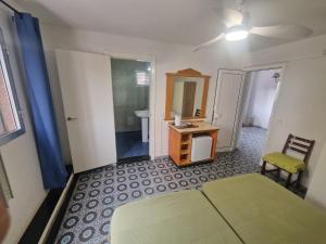 a bedroom with a bed and a sink and a mirror at Hostal Maxorata in Morro del Jable +54 photos