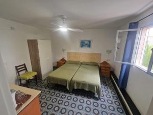 a bedroom with a bed and a chair in it at Hostal Maxorata in Morro del Jable