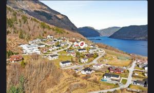 a small village on a hill near a body of water at U Maxa , całe mieszkanie na wyłączność in Sogndal