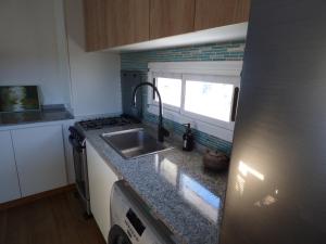 a kitchen with a sink and a counter top at Almahue in Quebrada de los Pozos +3 photos
