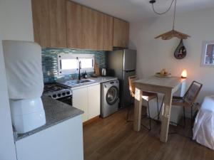 a small kitchen with a sink and a table at Almahue in Quebrada de los Pozos