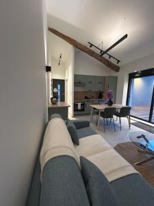 a living room with a couch and a table at Gîte Alice Piscine privée in Hauterives
