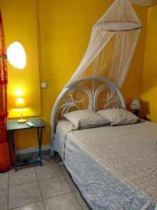 a bedroom with a bed with a white canopy at Nid du Lagon in Sainte-Anne