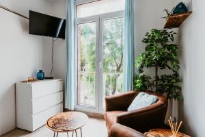 a living room with a chair and a large window at Appartement - Michelet in Le Havre