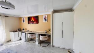 a room with a desk with stools in it at Jwalaboholo Mountain View Guest House in Ficksburg