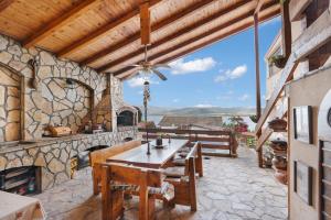 an outdoor patio with a table and a fireplace at Apartments by Proshevi in Star Dojran