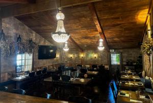 a dining room with tables and chairs and a chandelier at The Inn at Zaca Creek in Buellton