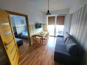 a living room with a couch and a table at Apartament Janka in Zator