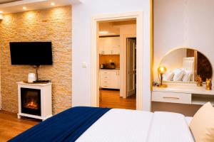 a bedroom with a bed and a fireplace and a television at Luxury Sea Residence by Kristina in Tivat