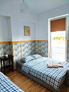 a bedroom with two beds and a window at Apartament Janka in Zator