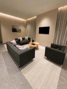 a living room with two couches and a tv at ملاذ 1 in Riyadh