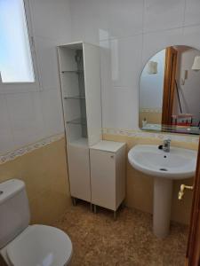a bathroom with a sink and a toilet and a mirror at Durino apartment with terrace in Moncófar