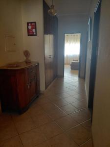 a room with a hallway with a door and a tiled floor at Gaivota Erudita in Buarcos