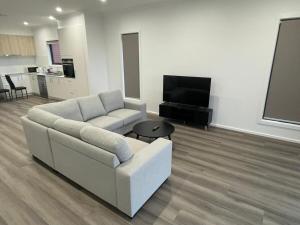 a living room with a couch and a flat screen tv at Darley Retreat in Darley