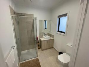 a bathroom with a shower and a toilet and a sink at Darley Retreat in Darley +3 photos