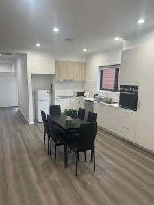 a kitchen and dining room with a table and chairs at Darley Retreat in Darley