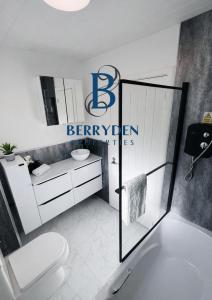 a bathroom with a white toilet and a sink at Aalesund stay in Peterhead