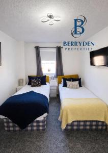 a bedroom with two beds and a sign that reads bennington properties at Aalesund stay in Peterhead