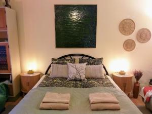 a bedroom with a bed with two towels on it at Arany Virág Vendégház in Mór
