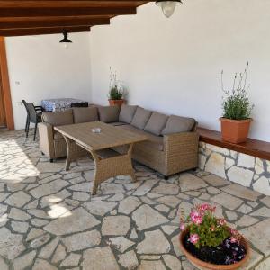 a living room with a couch and a table at Villa Yannis 1 in Roda +27 photos