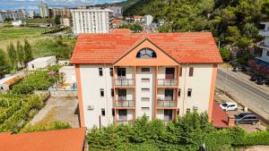 an apartment building with an orange roof at Hotel Xhejsoni in Shëngjin