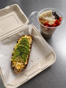 a sandwich with a pickle on it in a styrofoam container at Hotel Casa Majaal in Ixtapan de la Sal