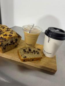 a cutting board with a loaf of bread and a cup of coffee at Hotel Casa Majaal in Ixtapan de la Sal
